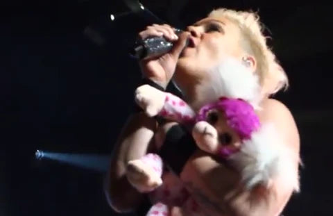 P!nk holding personalized stuffed pink monkey at concert